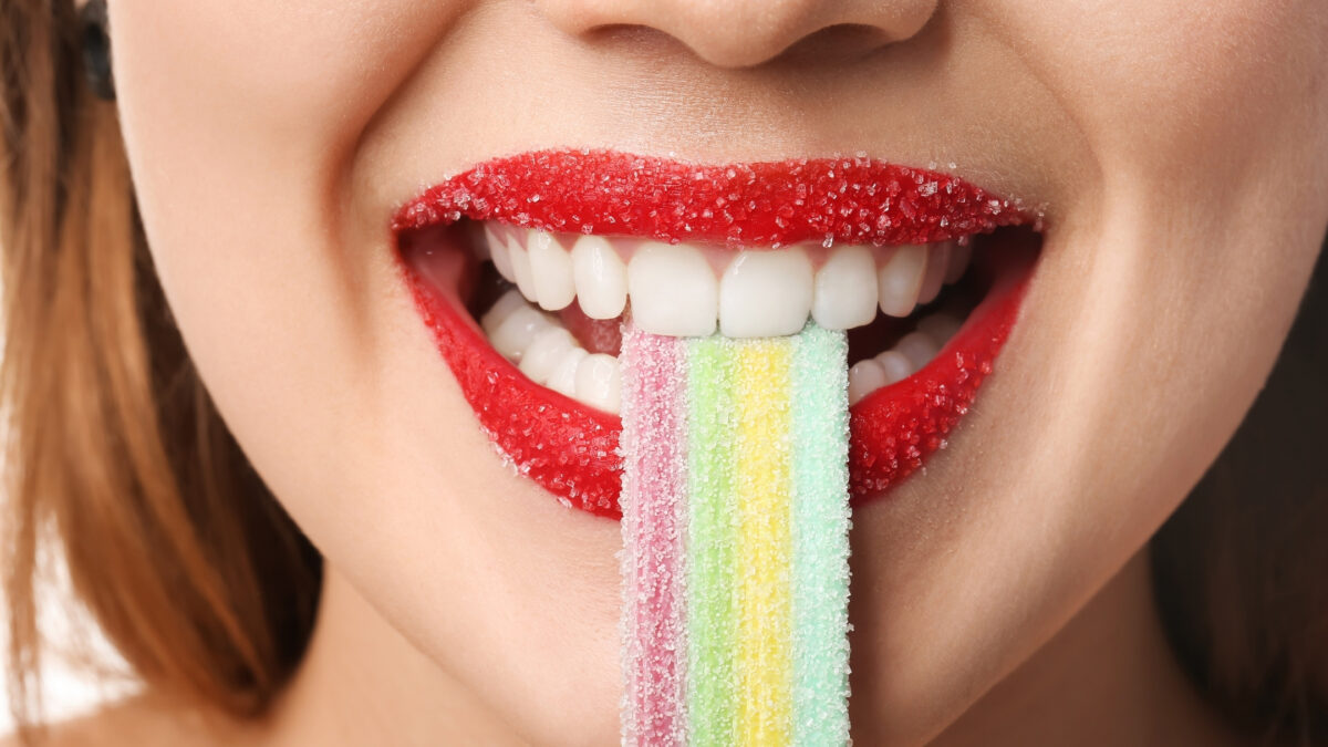 Props To Bring To A Photoshoot: A Woman Is Holding A Colorful Gummy Stick.