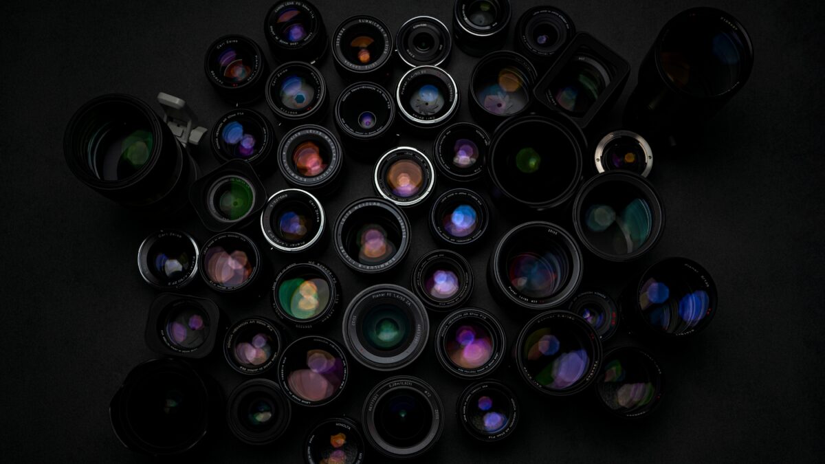 A Group Of Camera Lenses From A Photography Equipment List On A Black Background.