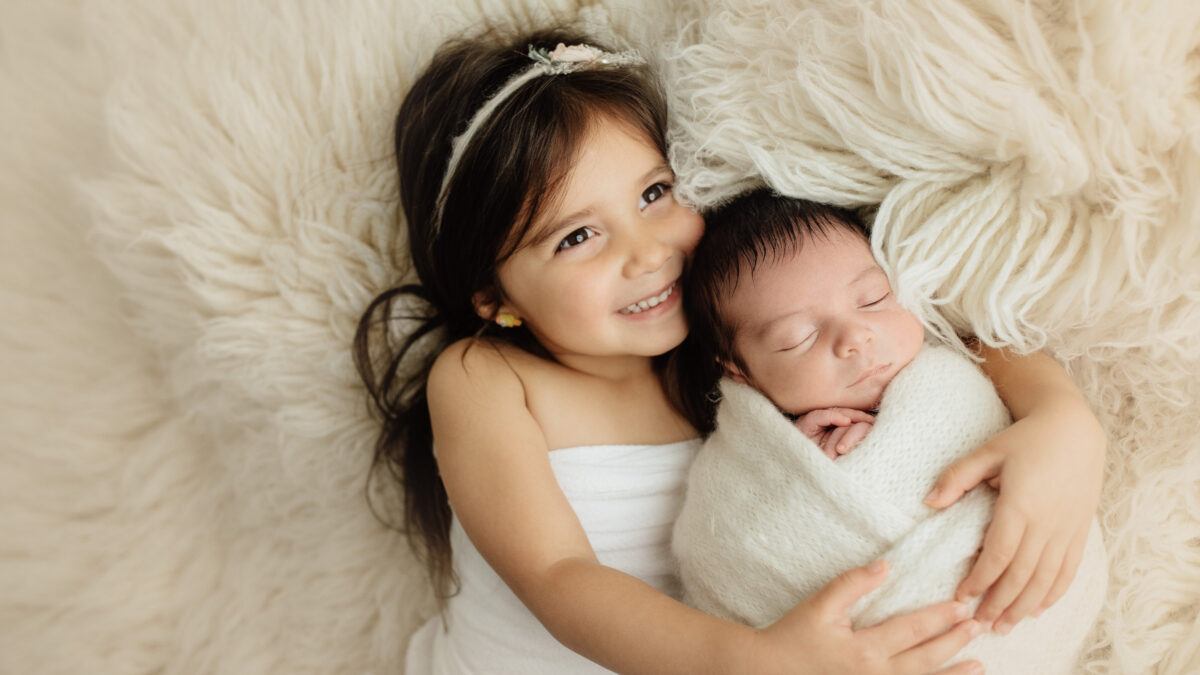 A Girl And A Boy Laying On A White Blanket, Captured Using Different Metering Modes.