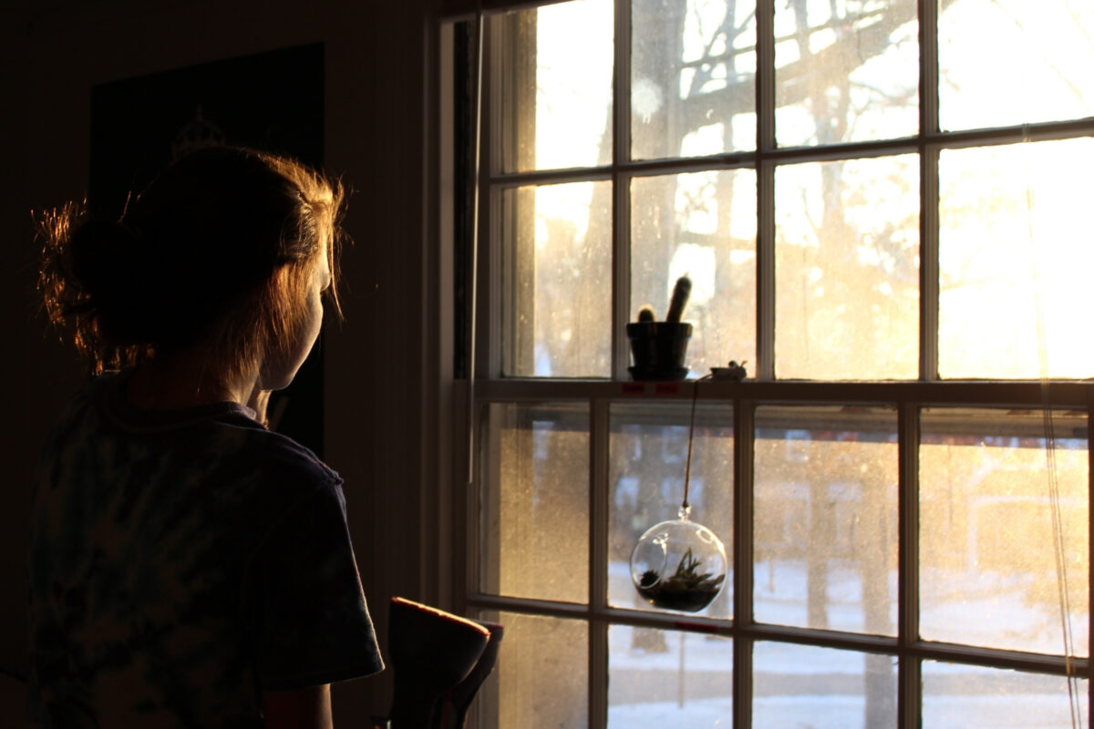 A Girl Framed By A Window, Showcasing A Remarkable Composition In Photography.