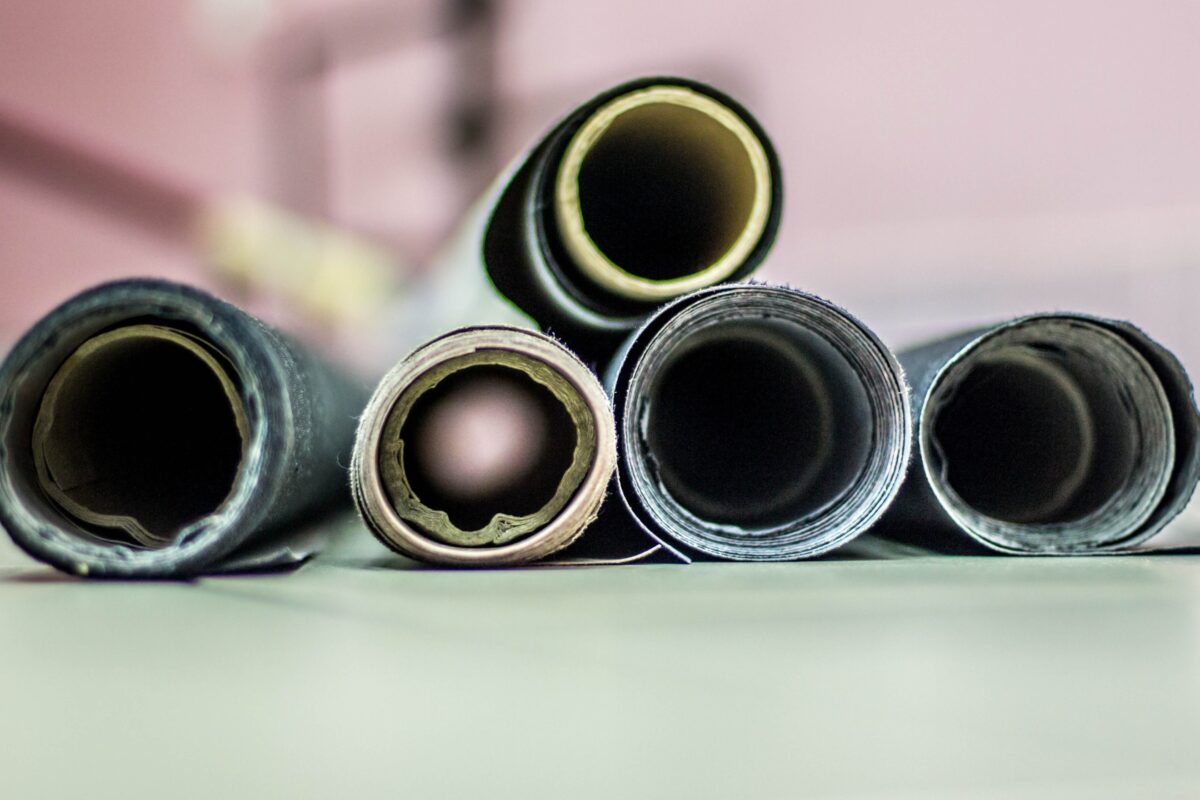 A Group Of Rolls Of Paper Sitting On A Table, Perfect For Photography Backdrops.
