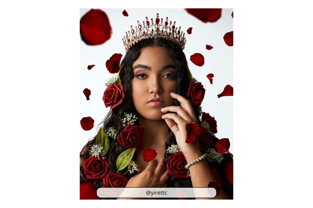 A Woman Adorned With A Crown Amidst A Picturesque Arrangement Of Roses, Capturing The Essence Of Why Photography Is Art.