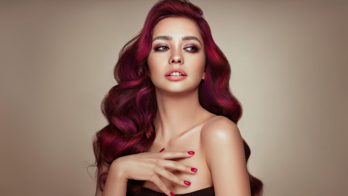 A Stunning Woman With Vibrant Red Hair Posing For A Captivating Portrait Photography Session.