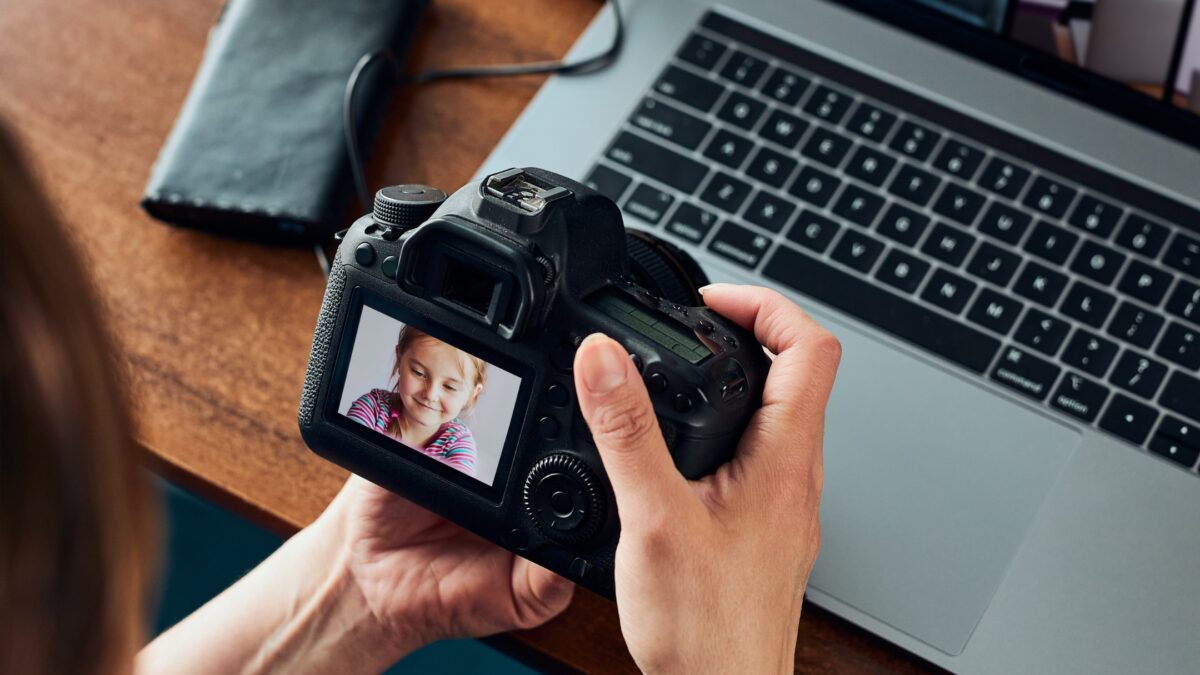 A Woman Is Taking A Picture Of A Person With A Camera.