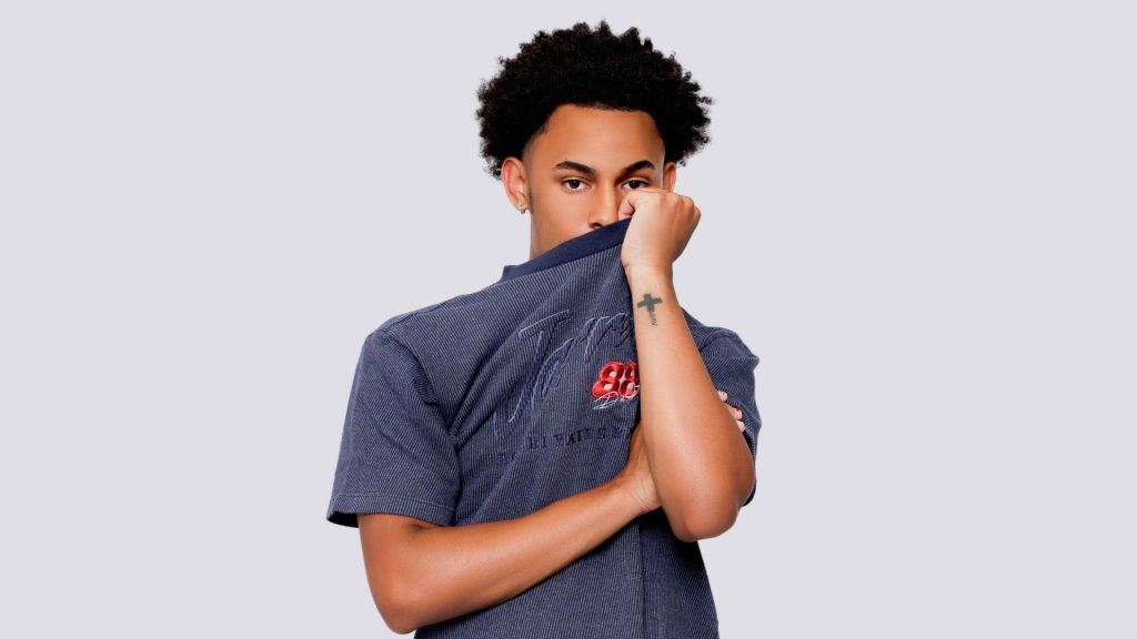 A Guy Holding Shirt Taking Pictures As An Introvert