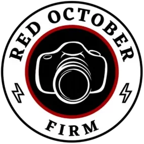 Red October Firm logo featuring a camera illustration in the center, surrounded by a circular text that reads "Red October Firm" with red and black outlines.